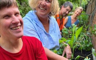 Vier unserer hauptamtlichen Mitarbeiterinnen und Mitarbeiter beim gemeinsamen freudigen Gärtnern an den Beeten im vereinseigenen Garten