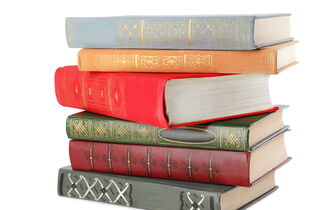 Mehrere Bücher mit Einbänden in unterschiedlichen Farben liegen auf einem Stapel